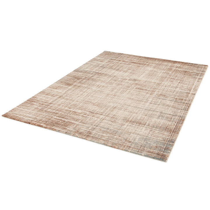 Angled view of a large beige and brown patterned rug.