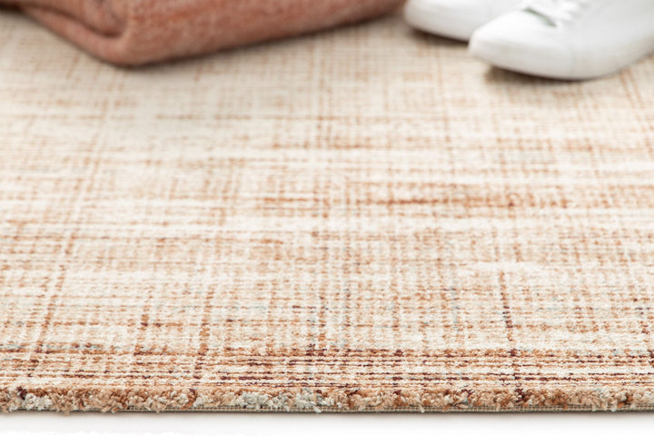 A brown and cream textured rug with a woven pattern.