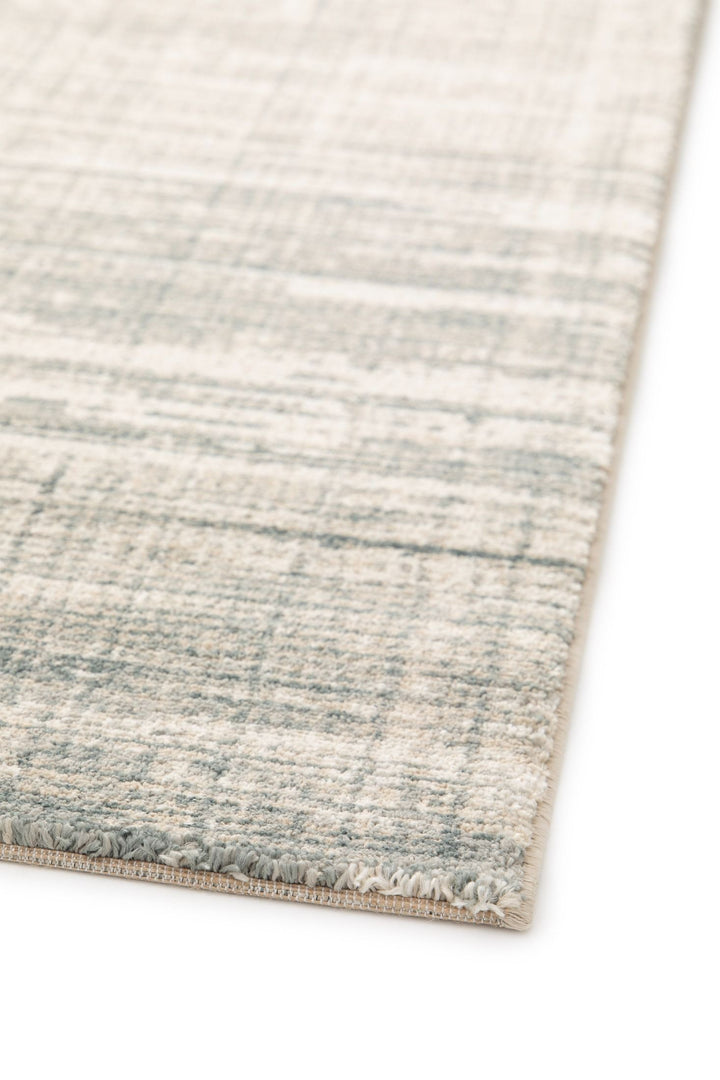 Detailed view of rug edge and soft texture.