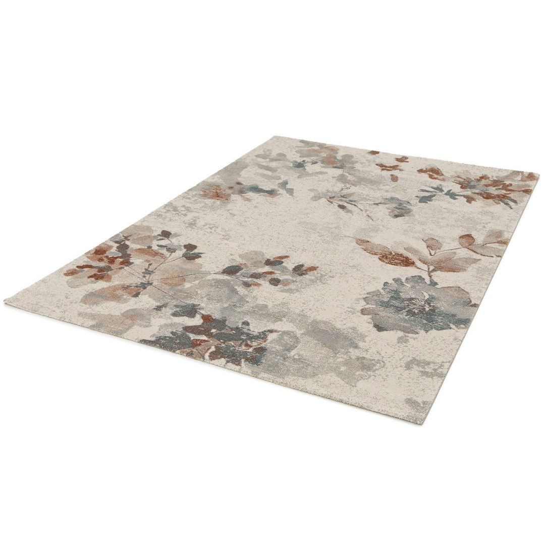 An angled view of a rectangular floral patterned rug on a white background.