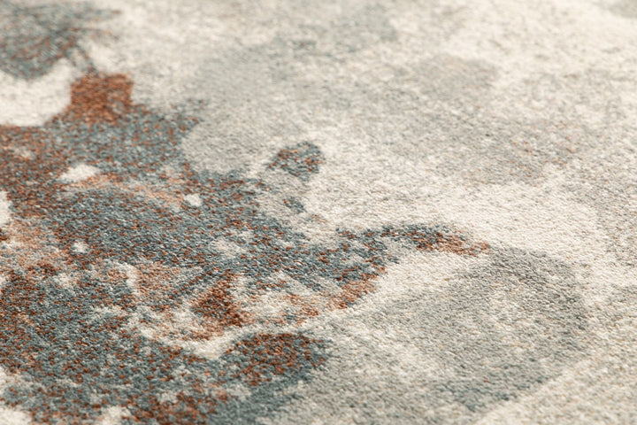 A macro shot of the rug’s floral pattern in blue and rust shades.