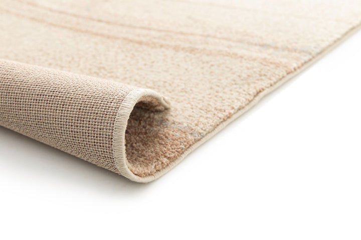 Beige and brown abstract rug displayed on a white background.