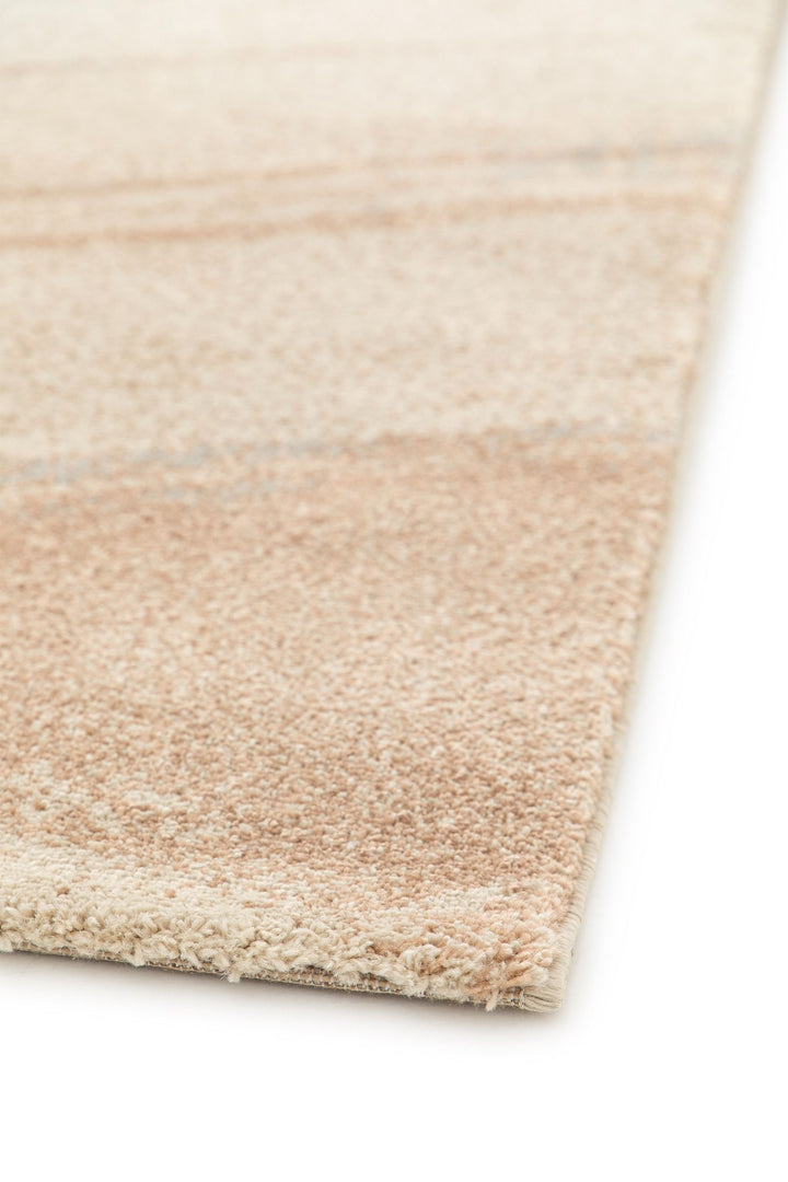 Close-up of rug corner rolled to show backing texture.