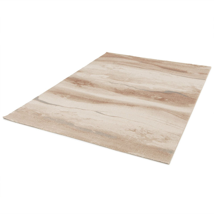 Edge view of a beige and brown abstract rug.