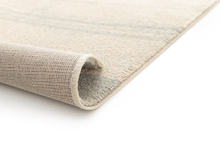 Beige and brown patterned rug angled view.
