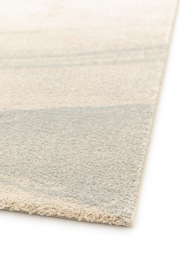 Close-up of rug edge with beige and gray texture.