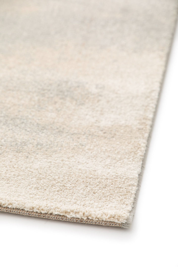 Close-up of rug corner in beige tones.