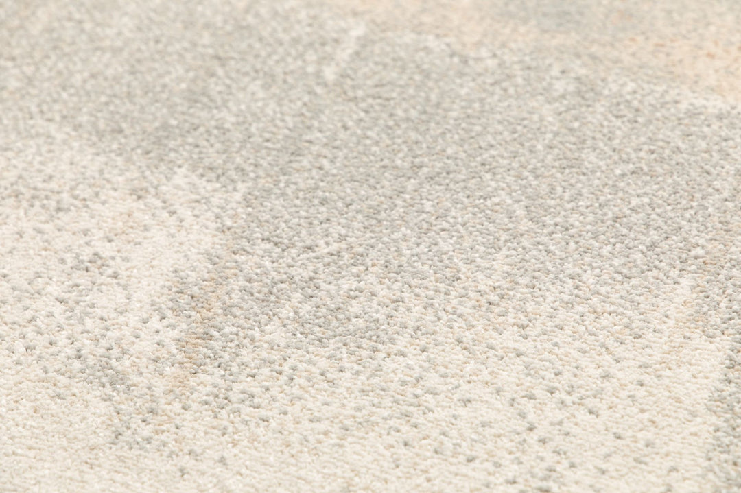 Close-up texture of soft grey rug fibers.