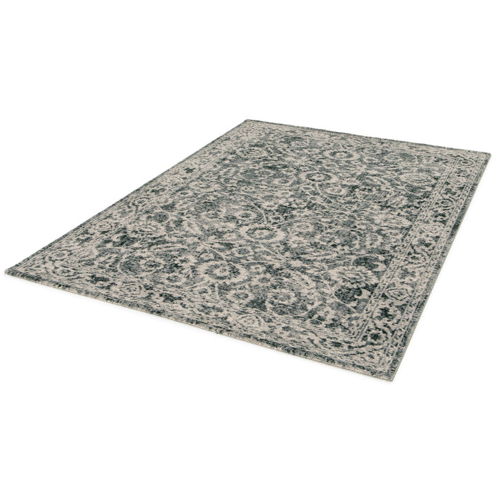 Modern rug in beige, grey, and rust tones on display.