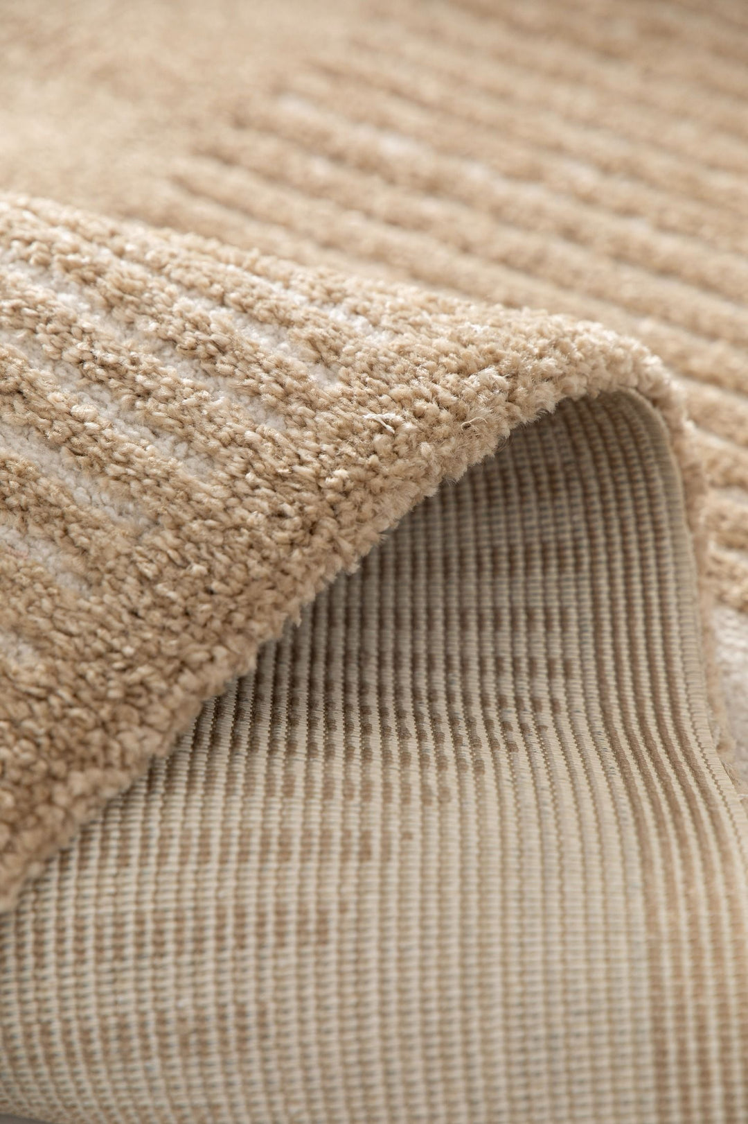 Folded edge showing rug backing.