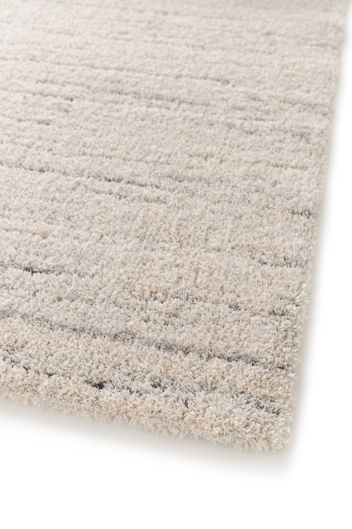 Soft beige rug corner close-up.
