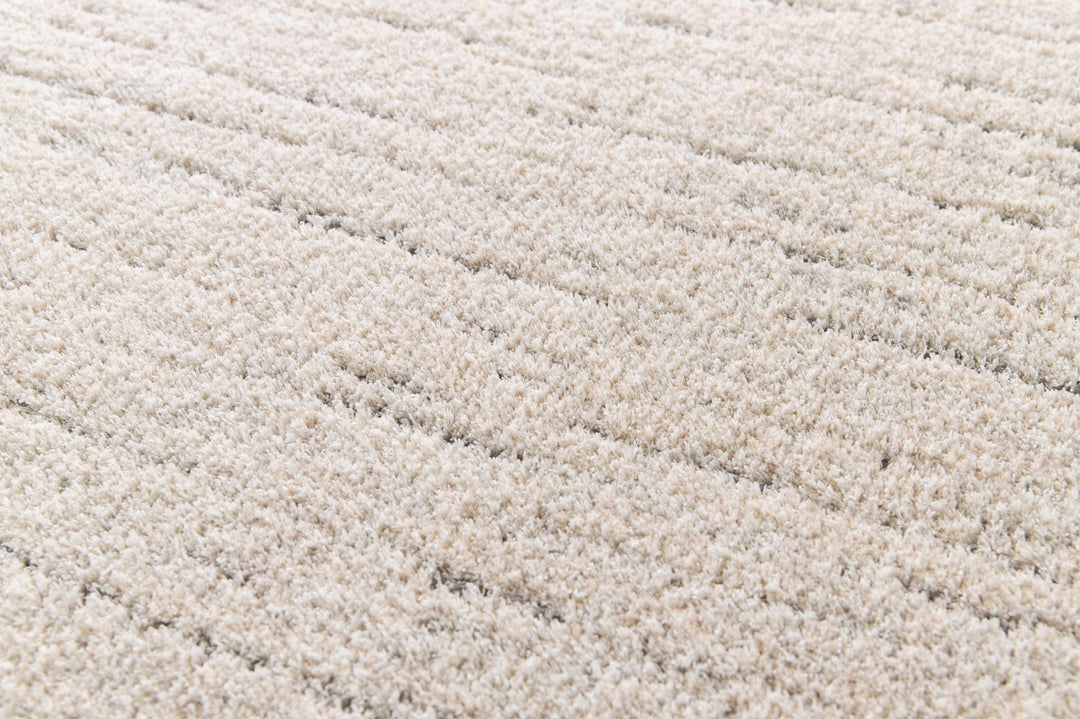 Close-up texture of beige rug.