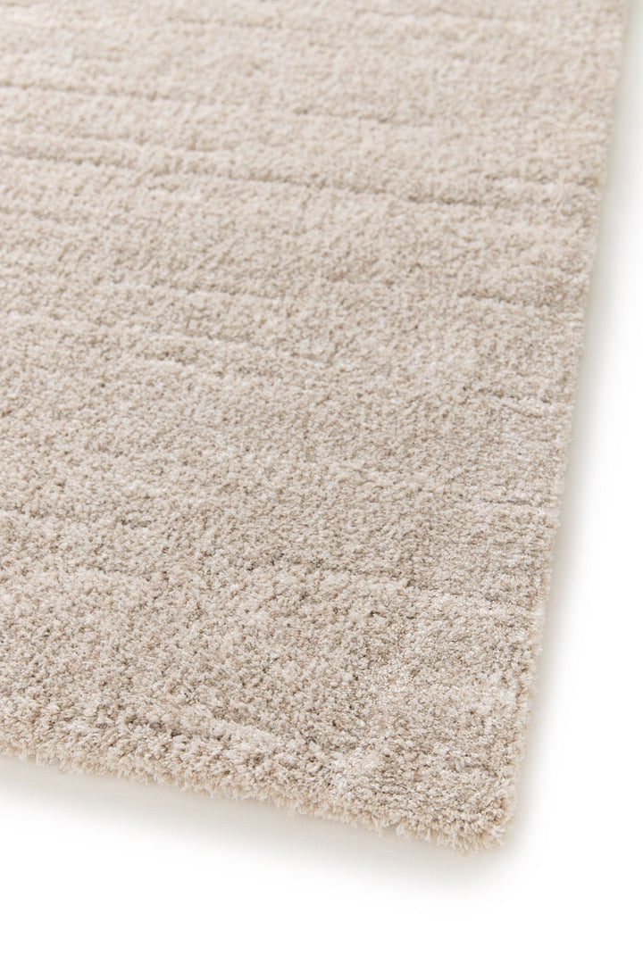 Angled close-up of beige rug texture.