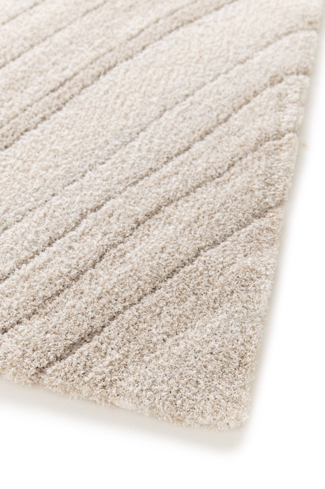 Angled close-up of beige rug texture with raised lines.