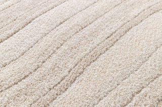 Close-up of plush beige rug surface with textured stripes.