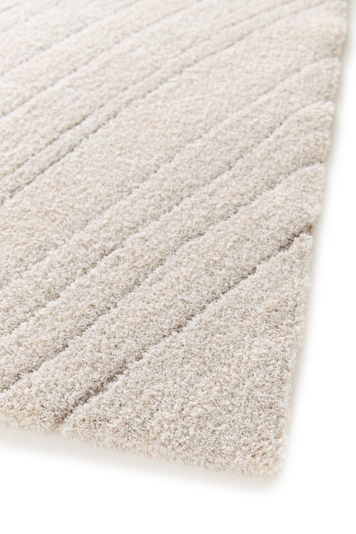 Angled close-up of cream rug with raised stripe details.