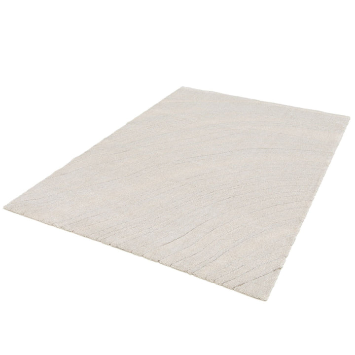 Full cream rug with faint wave-like line pattern.