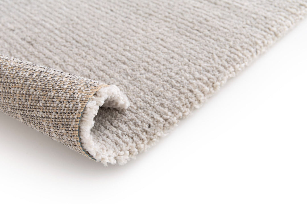 rug folded back view showing backing texture.
