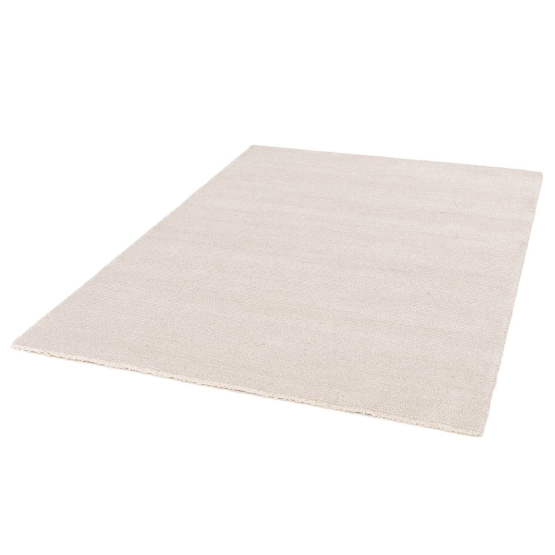 Angled view of a rectangular beige rug on a white background.