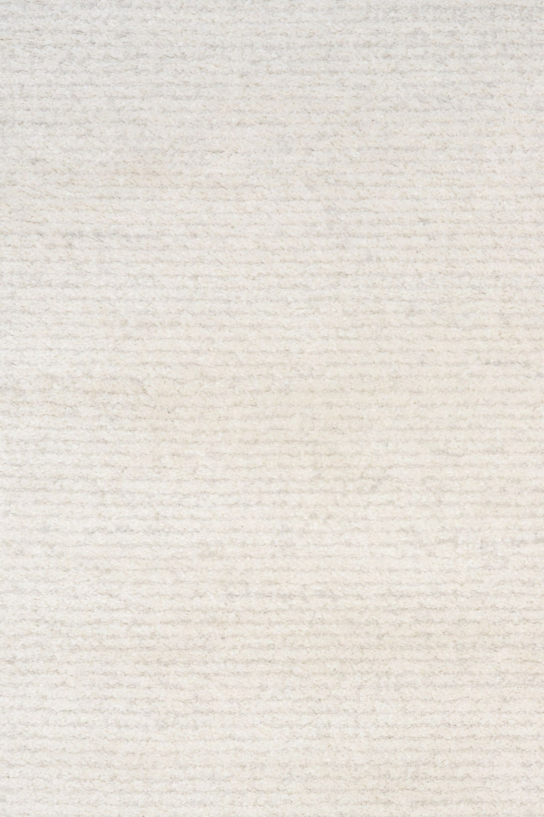Close-up of soft white rug texture with subtle horizontal lines.