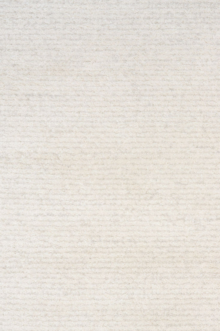 Close-up of soft white rug texture with subtle horizontal lines.