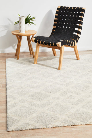 Alpine 855 Pebble area rug styled in family room with natural wood and neutral furnishings mid shag