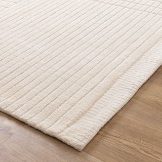 Edge detail of ivory rug highlighting thickness and soft texture.