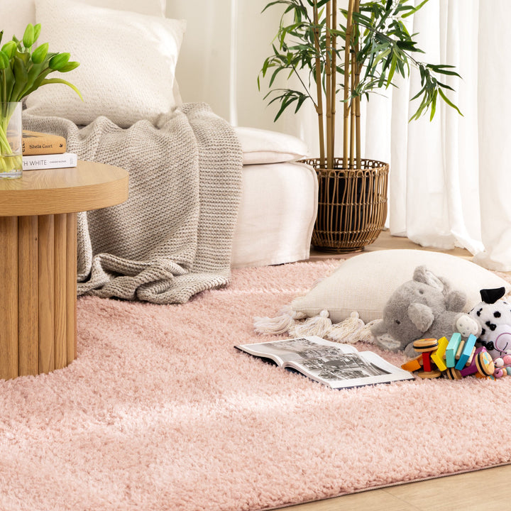 Lune Blush Pink Shaggy Rug flat lay — top-down view showing full rug size and blush pink tone in a living room.