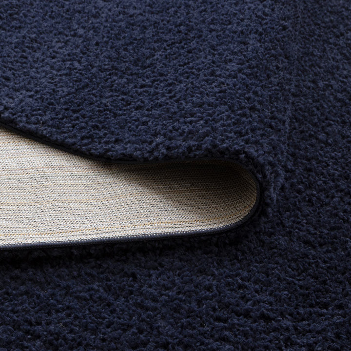 Lune Navy Shaggy Rug corner detail showing 40mm pile depth and rug backing