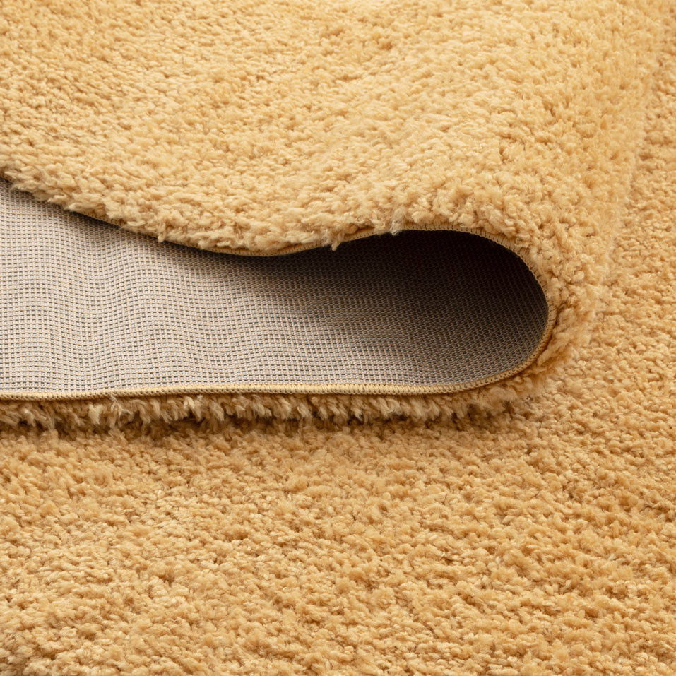 Lune Ochre Shaggy Rug corner detail showing 40mm pile depth and rug backing