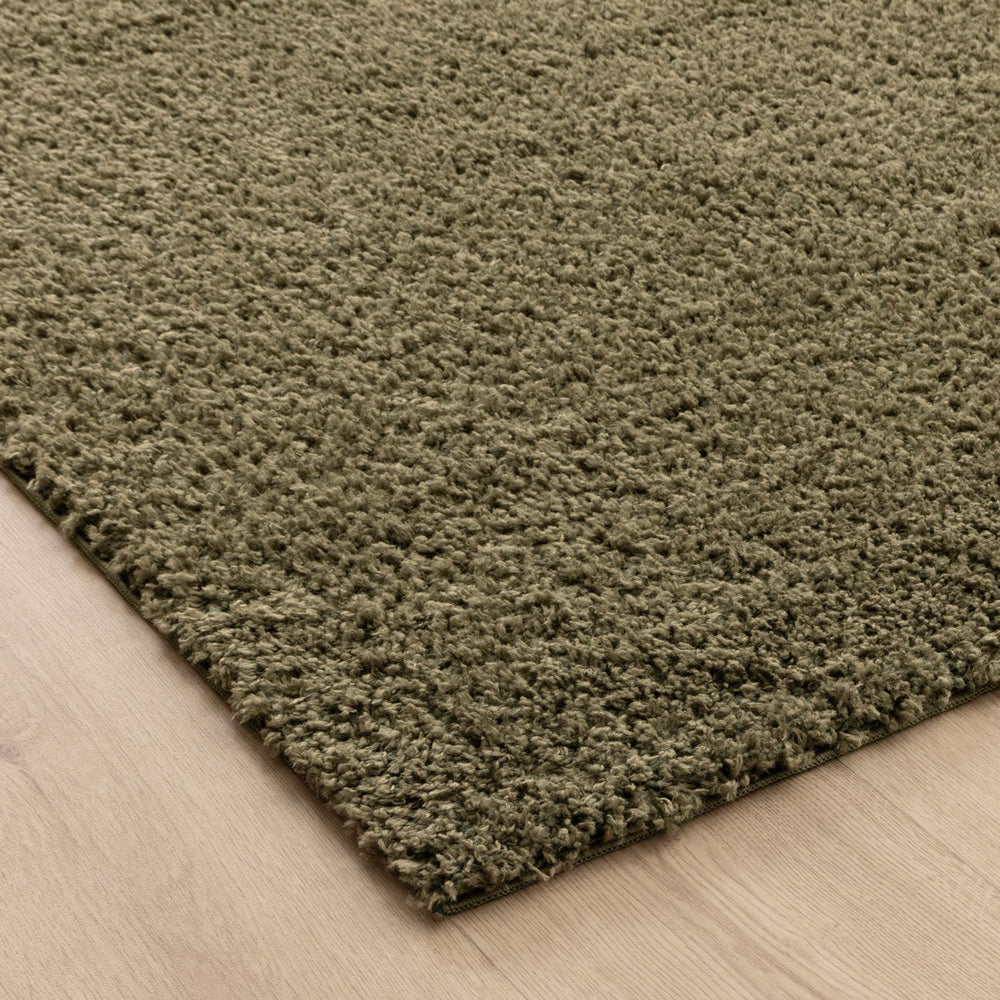 Close-up of Lune Olive Green Shaggy Rug pile — 40mm ultra-soft non-shedding polyester