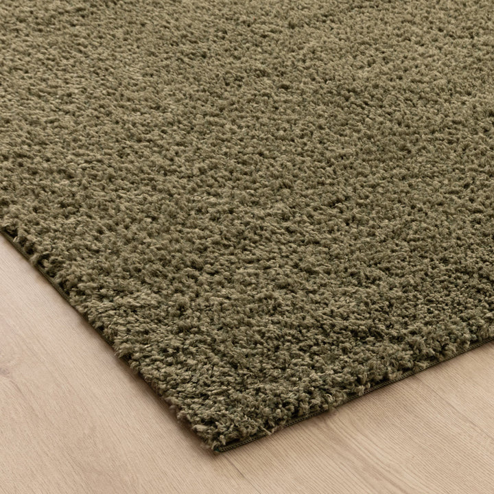 Close-up of Lune Olive Green Shaggy Rug pile — 40mm ultra-soft non-shedding polyester