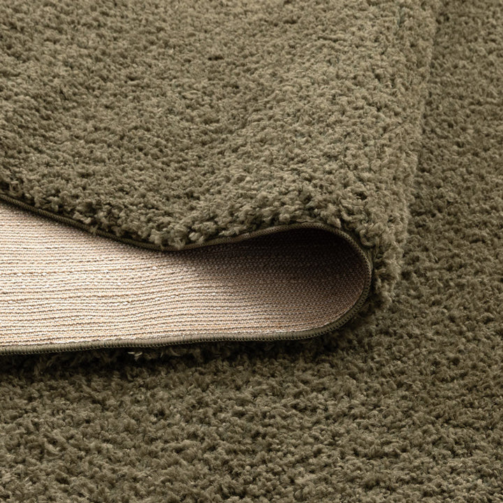 Lune Olive Green Shaggy Rug corner detail showing 40mm pile depth and rug backing