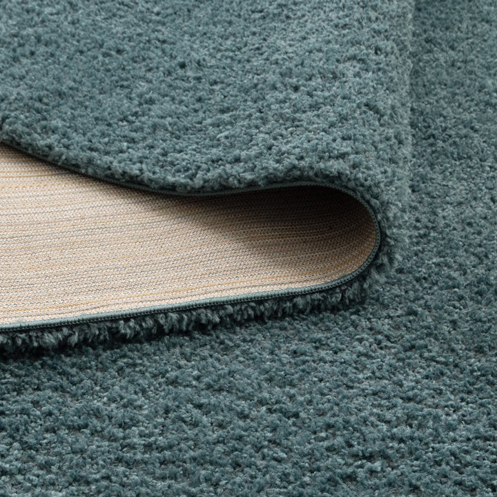 Lune Teal Shaggy Rug corner detail showing 40mm pile depth and rug backing