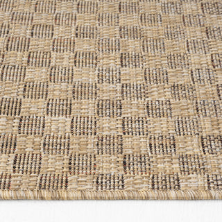 Close-up of a woven textured mat with a geometric pattern on a white background