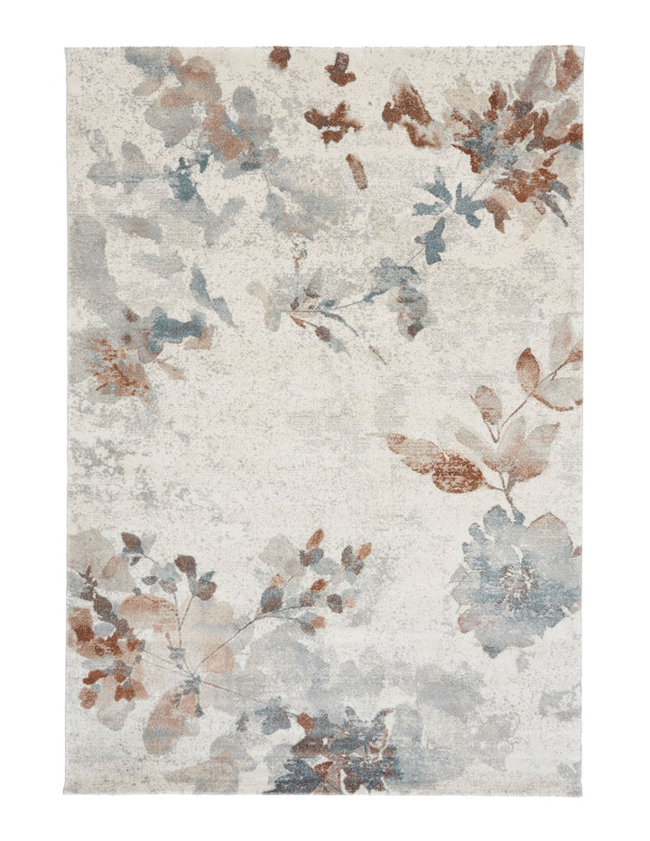A full overhead view of a beige rug with floral designs in blue and rust.