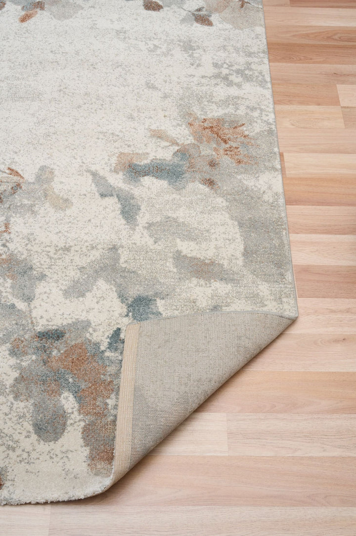 Rug corner folded to reveal backing and stitching.