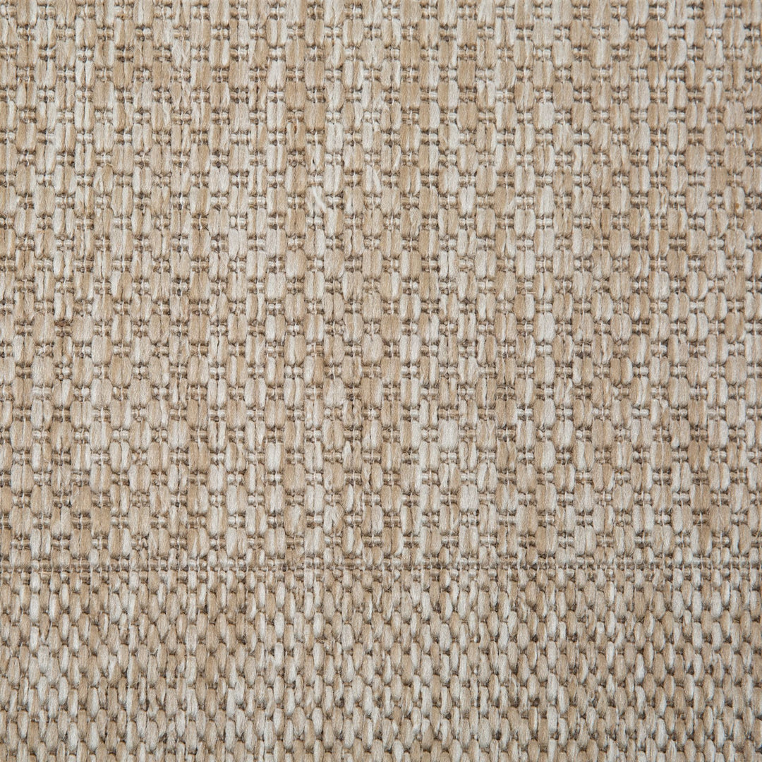 Close-up of sand rug woven surface.