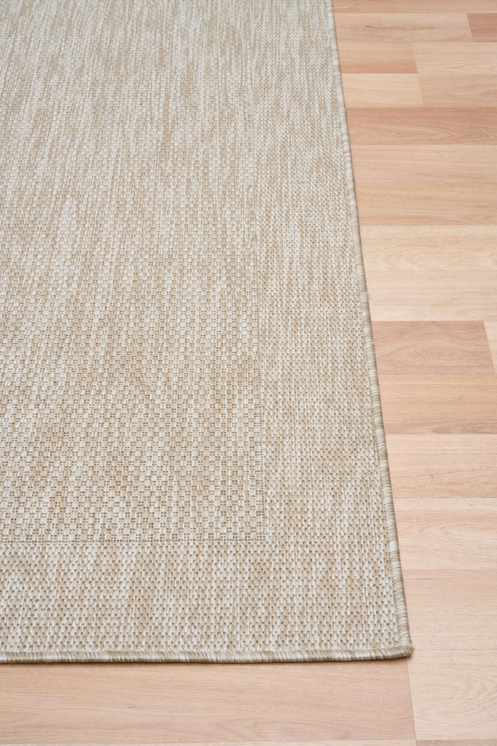 Corner view of dawn foam rug on wooden floor.