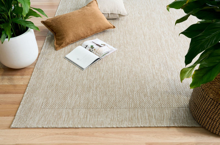 Styled room with dawn foam rug, cushions, and plant.