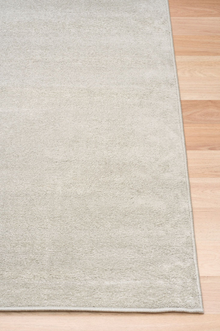 Close-up of beige rug corner.