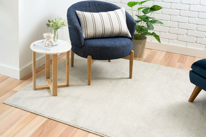 Beige rug with blue chair.