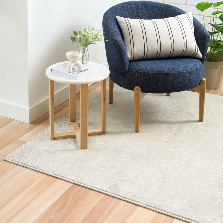 Beige rug under chair and table.