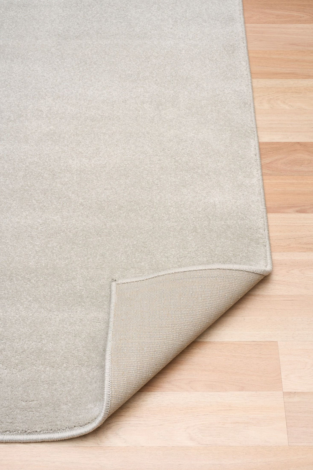Folded corner view of Eclipse Presidente rug showing backing.