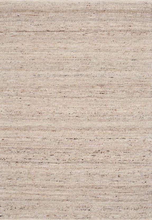 Top view of a beige textured rug with subtle variations in tone.