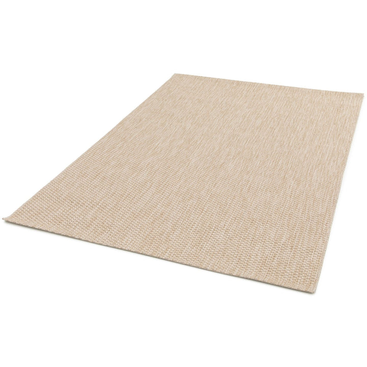 Three-quarter view of a light ivory-beige flat-woven rug on a white background, showing its low-profile edge and subtly heathered, tight texture.
