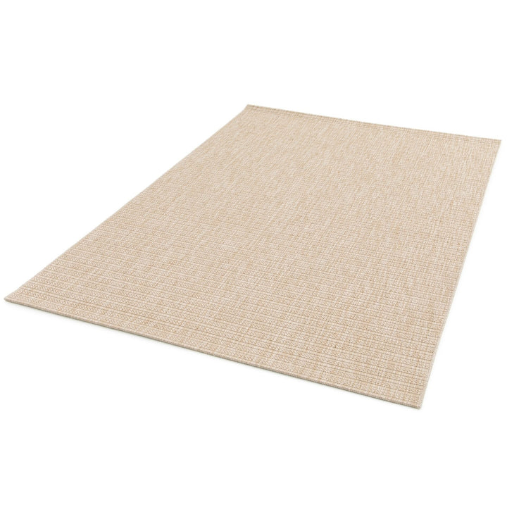 Beige woven rug with subtle diamond lattice pattern, three quarter view on a white background.