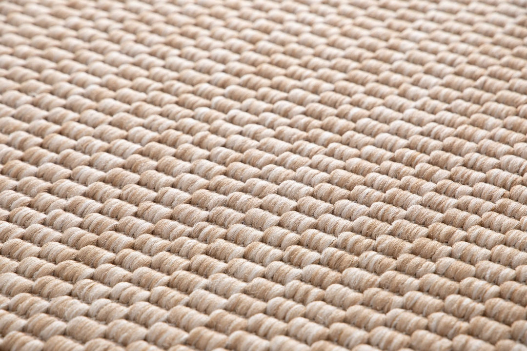 Macro close-up of the Barton indoor/outdoor rug in Sand (41503-070), showing the chunky two-tone basketweave loops in beige and ivory.
