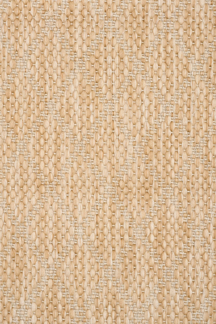 Close-up swatch of a tan woven rug featuring a raised diamond lattice pattern in heathered beige tones.
