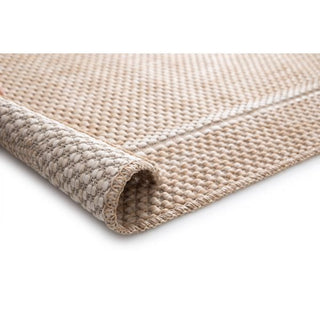 Close-up of Barton 41505/70 rug in warm beige, basket-weave texture, corner rolled to reveal the underside and stitched edge on a white background.